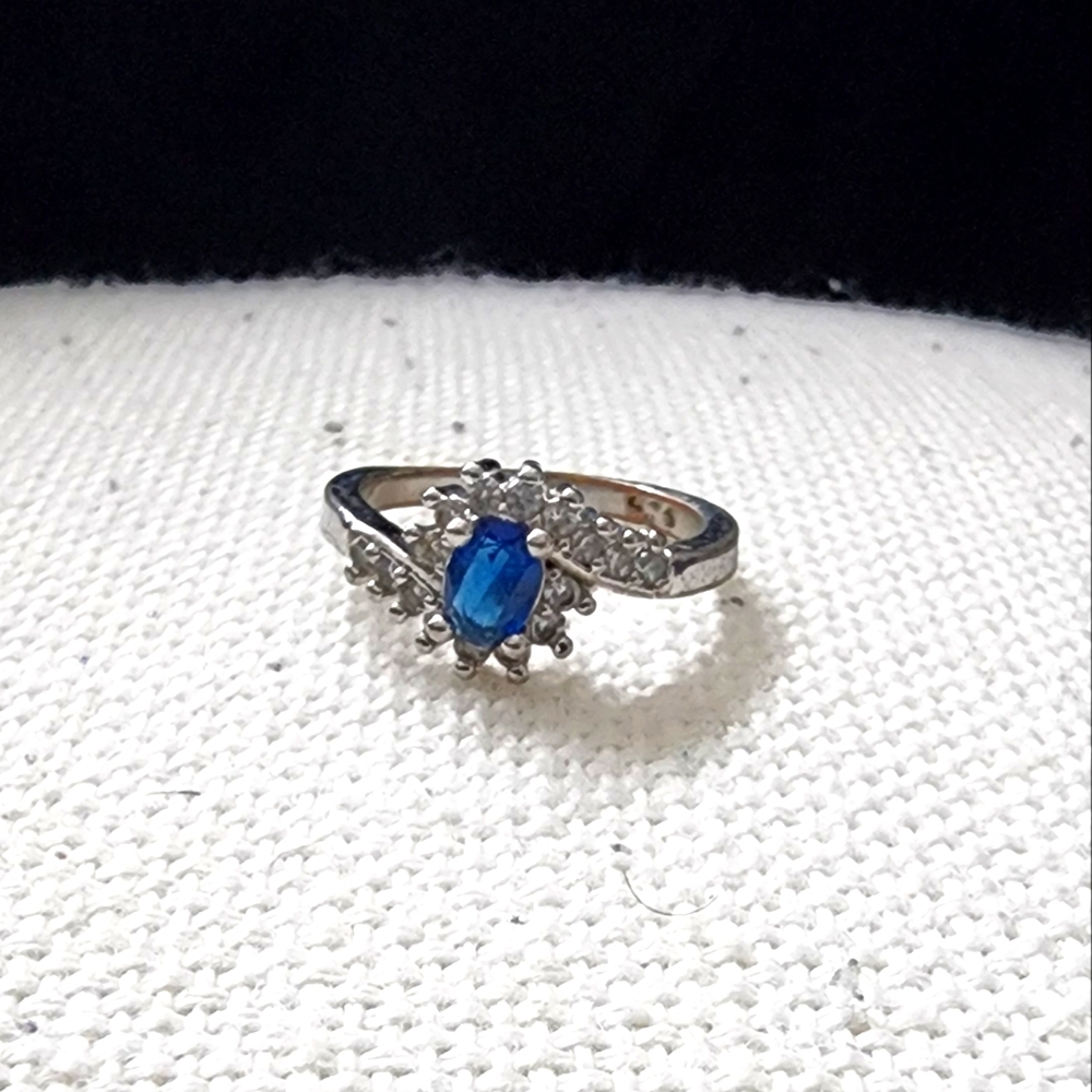 Blue Topaz with a twisted cubic Zirconia accent ring